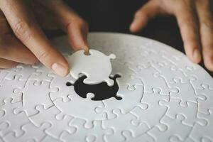 Concept of business, Hand put the last piece of jigsaw puzzle to complete the mission. photo