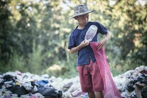 Child labor. Children are forced to work on rubbish. Poor children collect garbage. Poverty,  Violence children and trafficking concept,Anti-child labor, Rights Day on December 10. photo