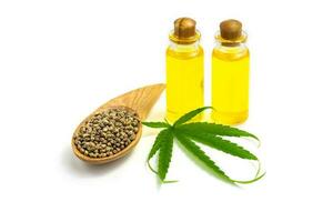 Hemp seeds and hemp oil on white background, CBD cannabis oil extract, marijuana  alternative herbal medicine concept. photo