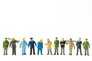 Miniature people different professions standing on white background , Labour day concept photo