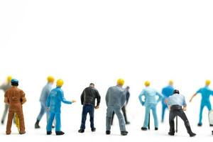 Miniature people , Worker team standing on white background, Labour day concept photo