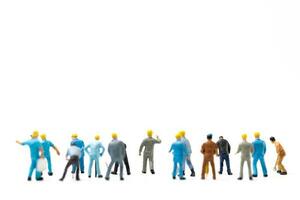 Miniature people , Worker team standing on white background, Labour day concept photo