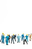 Miniature people , Worker team standing on white background, Labour day concept photo