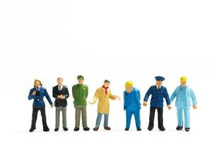 Miniature people different professions standing on white background , Labour day concept photo