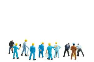 Miniature people , Worker team standing on white background, Labour day concept photo