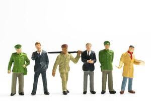 Miniature people different professions standing on white background , Labour day concept photo