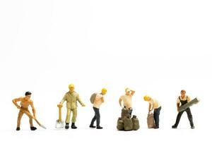 Miniature people , Worker team standing on white background, Labour day concept photo