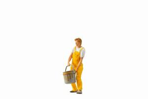 Miniature people, Painter holding paint bucket on white background with clipping path photo