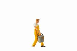 Miniature people, Painter holding paint bucket on white background with clipping path photo