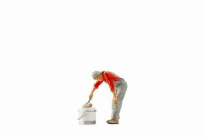Miniature painter holding paint roller isolated on white background with clipping path photo