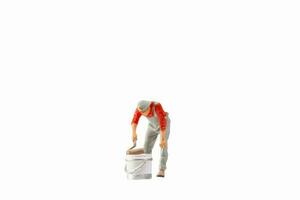 Miniature painter holding paint roller isolated on white background with clipping path photo