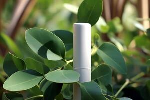 A mock-up of a tube of white cream with a lid on a background of eucalyptus leaves. photo