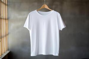 A white T-shirt is hanging on a hanger. photo