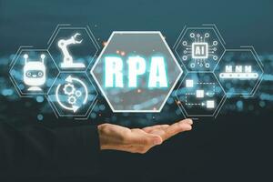 RPA Robotic Process Automation Innovation technology concept, Person hand holding VR screen RPA icon on office desk background. photo