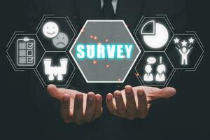 Survey concept, Business person hand holding survey icon on virtual screen. photo