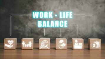 Work life balance concept, Wooden block on desk with work life balance icon on virtual screen. photo