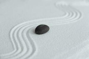 Zen Garden with Grey stone on White Sand Wave Pattern in Japanese stye, Rock Sea Stone on Sand texture with the wave parallel lines pattern,Harmony,Meditation,Zen like concept photo