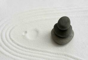 Zen Garden with Stack stone on white Sand line pattern in Japanese stye, Rock Sea Stone on Sand texture with the wave parallel lines,Spa Therapy,Purity harmony and Balance ,Meditation,Zen like concept photo