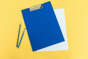 A set of blue stationery as a template with a place to copy on a yellow background, pen and pencil photo