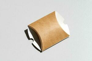 The box made of craft cardboard is collapsible. Gift box made of kraft paper photo