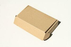 Rectangular closed box made of corrugated cardboard on a white background photo