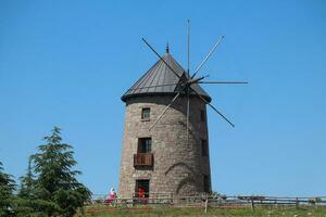 Windmill and blue sky. Photo of windmill with harvests