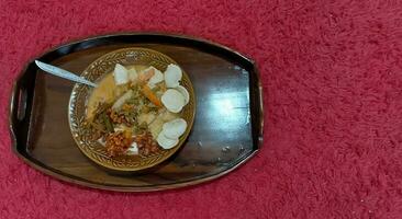 Delicious lontong food ready to serve red background. photo