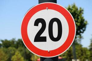 Regulatory signs, maximum speed limit traffic sign 20 KM. photo