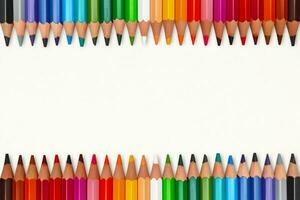 Tow rows of colorful crayons in line with copy space photo