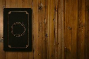 Book with a gilded Ouroboros on a wooden desk photo