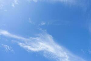 Blue sky and white cirrocumulus clouds texture background. Blue sky on sunny day. Summer sky. Cloud formation. Fluffy clouds. Nice weather in summer season. Weather pattern. Atmospheric phenomenon. photo