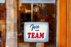 Join our team sign in a store window photo