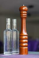 Pepper grinder and two bottles of water photo