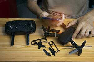 Professional mechanic repairing a drone, setting it up, on a table with various tools. in modern workshop photo