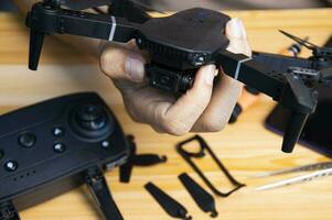 Professional mechanic repairing a drone on the table with various tools in modern workshop photo