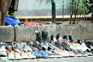 Jakarta, Indonesia-18 June 2023 second hand shoe seller on a city street photo