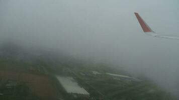 View from airplane on the airport through the window with rain drops and streams video