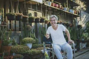 asian senior man smiling with happiness face at home garden photo