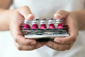 Many colorful pills in woman hand. Concept of medicine and supplement in hospital and medical business. photo