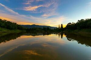 Beautiful sunset sky with reflection of the lake at Khao Yai national park, Thailand photo