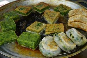 Garlic Chives Cakes on pan with boiling oil, Asian style food photo