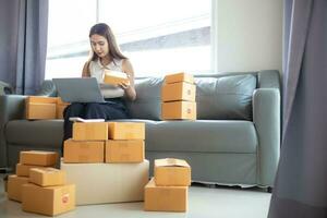 Many parcel boxes are prepared and inspected before calling shipping company to pick up parcel for delivery. entrepreneurs SMEs have prepared parcel boxes for delivery after receiving orders photo