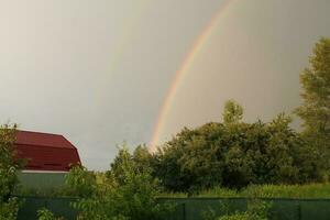 Full rainbow after rain against the sky photo