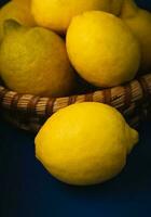 Basket with ripe lemons. On a rustic blue dark background. High quality photo