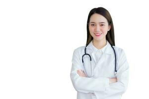 Professional Asian woman doctor wearing a white robe and stethoscope Standing with arms crossed happy and smile at the examination room in the hospital. photo