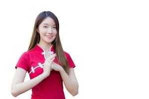 Cheongsam dress in Chinese new year theme while she shows her hand as Chinese greeting while isolated on white background. photo