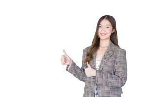 Asian professional woman with black long hair wearing plaid suit and pretty smiling looking at camera while present product thumbs up means good while isolated on white background. photo