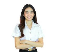 Portrait of adult Thai student studying at university. Beautiful Asian young woman student in uniform is smiling with her arms crossed confidently isolated on white background. photo