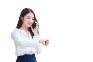 Portrait professional business Asian woman is walking to office or work place while she looks at watch and talks on the phone with smartphone isolated on white background. photo