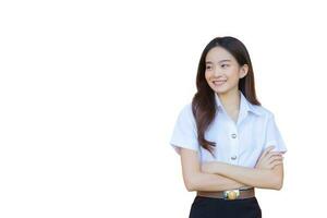 Portrait of an adult Thai student in university student uniform. Asian beautiful girl standing smiling happily and confidently with her arms crossed while isolated on white background. photo